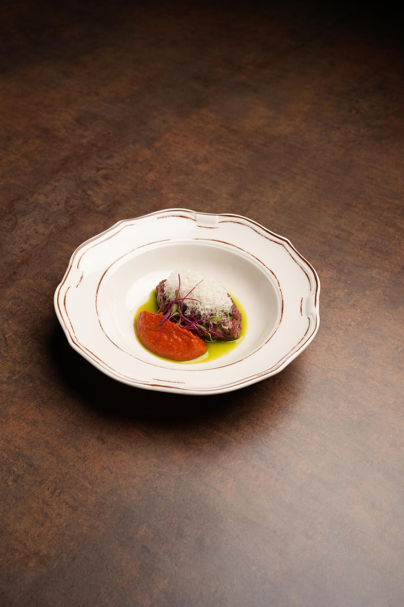 Plated seasonal tasting menu on ceramic plate